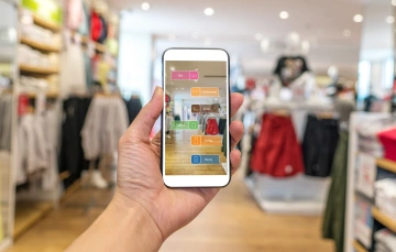cell phone with augmented reality image in clothing shop